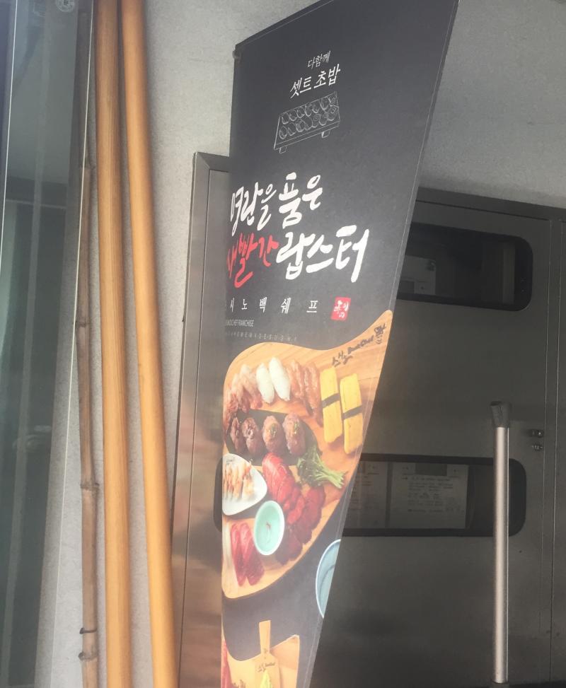 2번출구 4번출구 사이에 seize your day라는 카페 옆에 저런 현수막이 있어. 그 옆에 놓여있는 테이블 뒤에 숨겼어! 10분정도 서있었